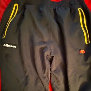 Black ellesse lightweight pants with yellow detail